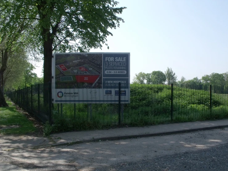 a sign with an open field behind it