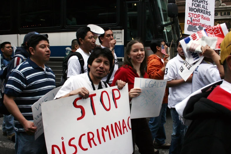people holding signs protesting at an event