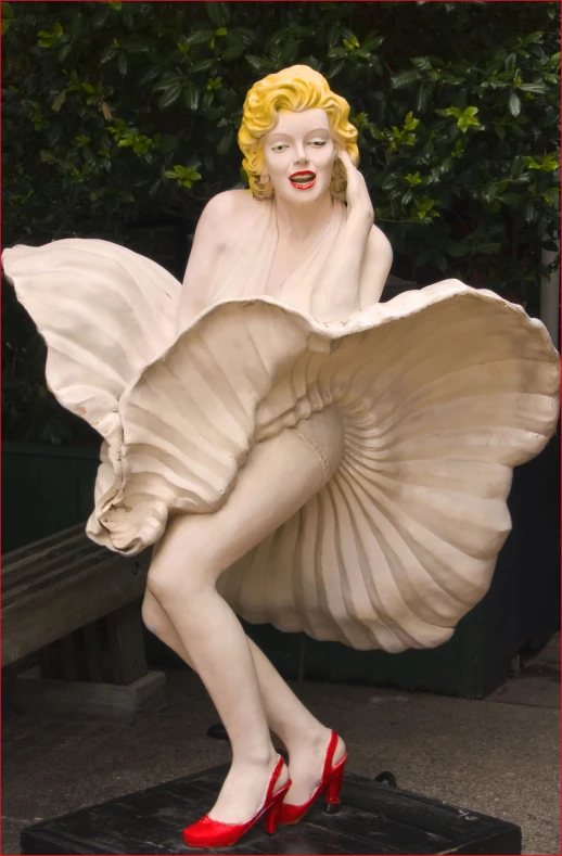 a statue of a woman in a red and white outfit