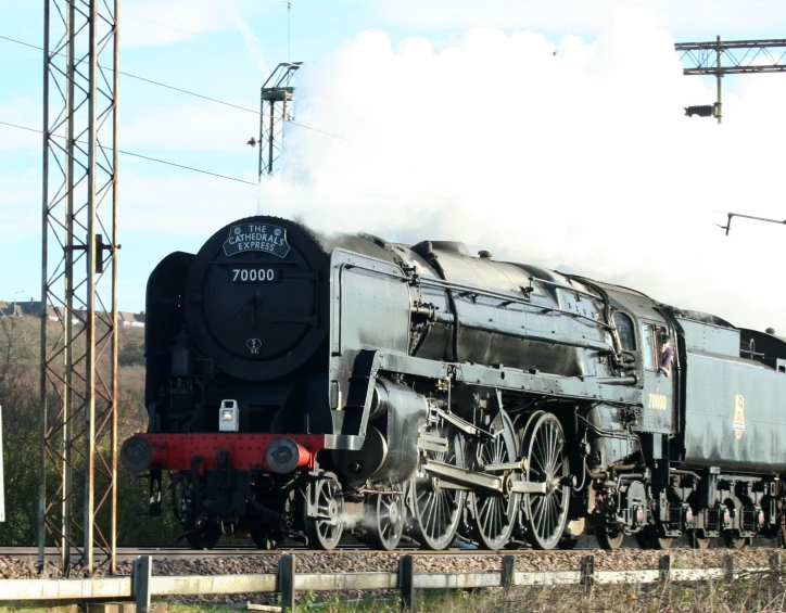 the old fashioned locomotive is traveling on the tracks