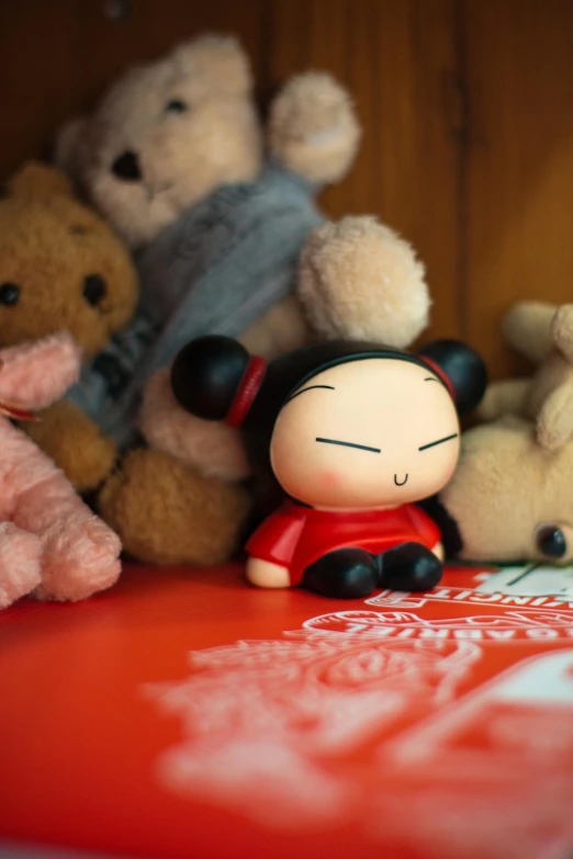 a red table with stuffed toys and a red cover