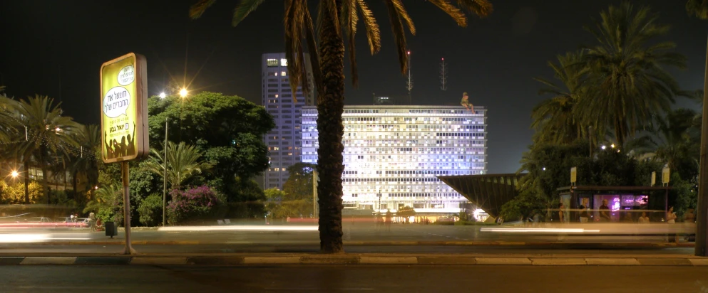 a building in the background with lots of lights on it