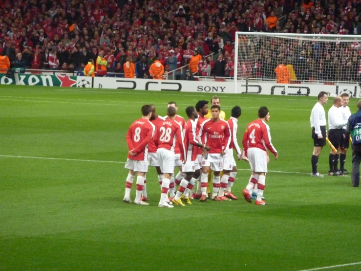 players huddle on the field for a group po