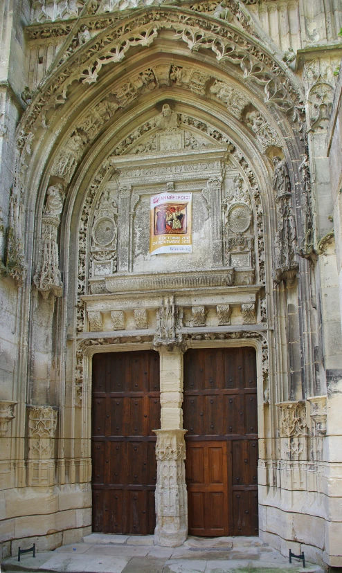 the interior of an old cathedral with wooden doors