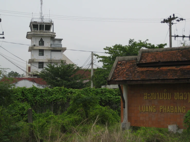 an old fashioned clock tower standing in the background with buildings