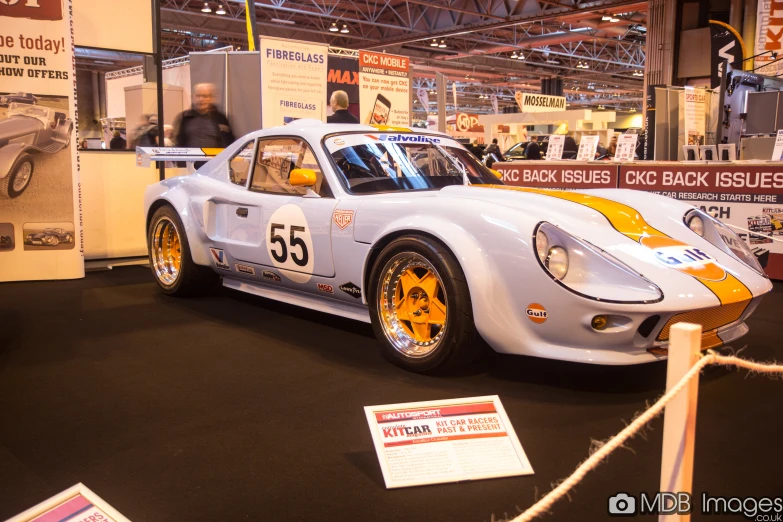 a race car is parked on a show floor