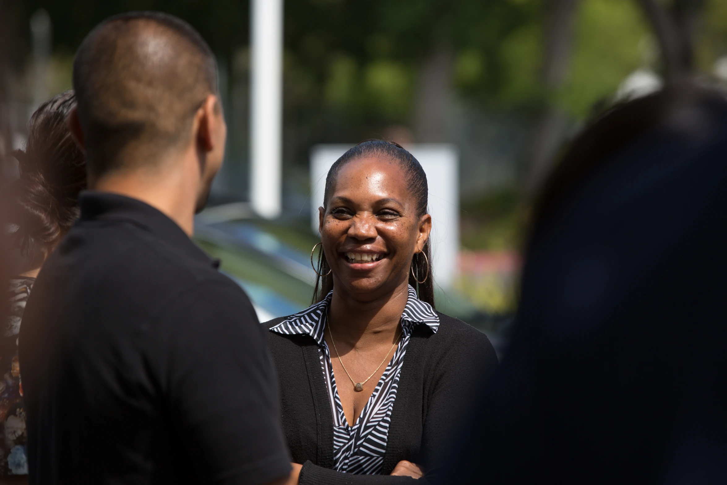 a woman standing with two other people in a crowd