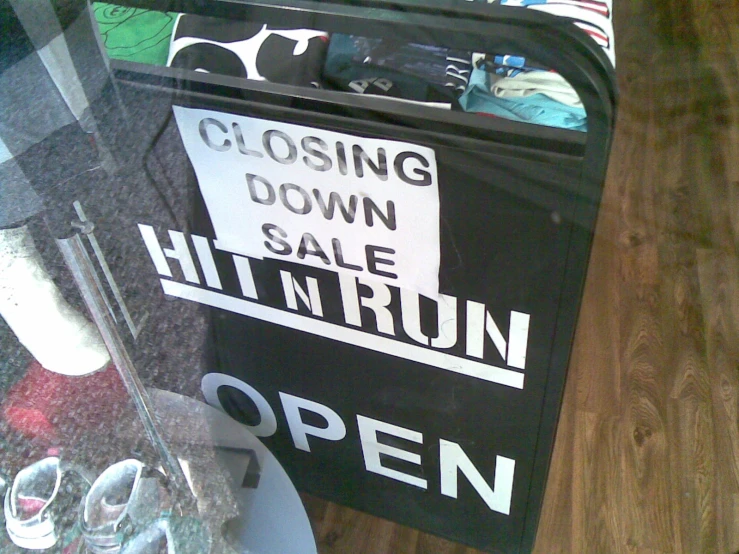 a closed sign on the back of a black suitcase