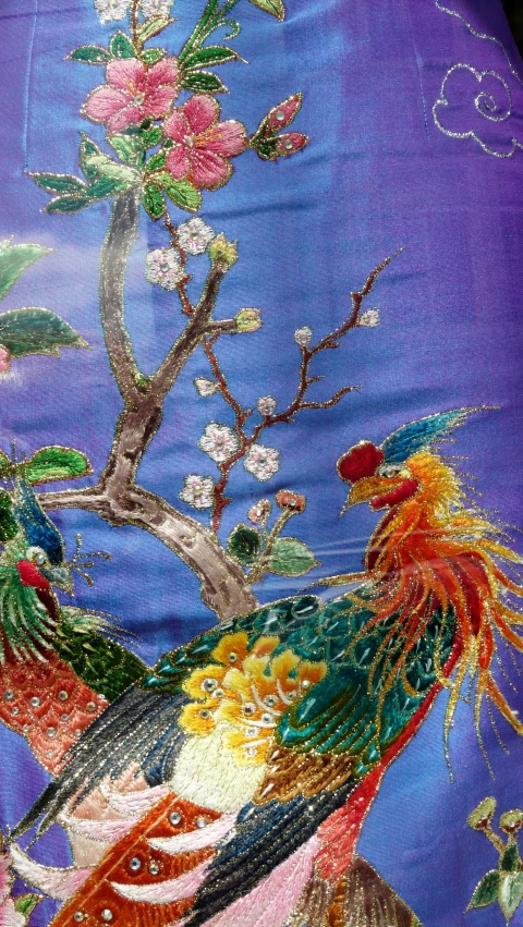 the colorful fabric has some flowers and birds