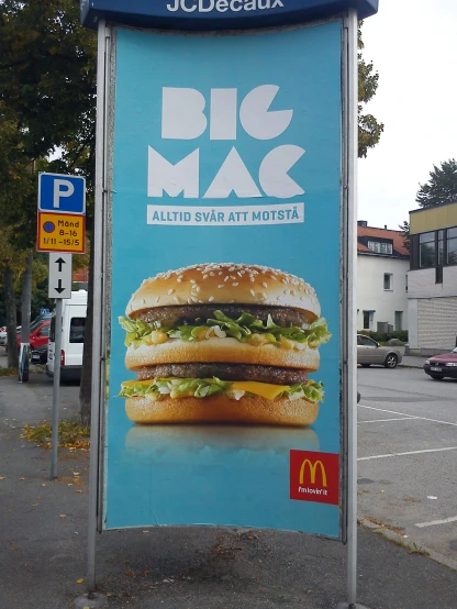 a large advertit for big mac on a city street