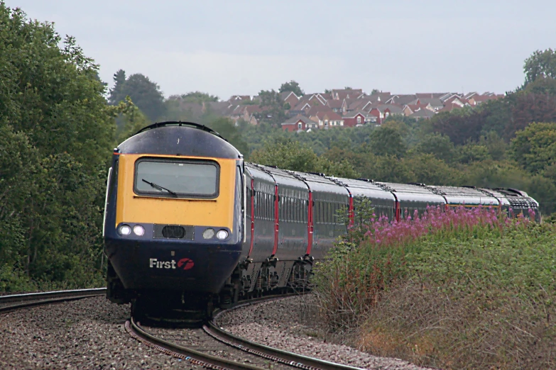 a train moving along the track in rural countryside