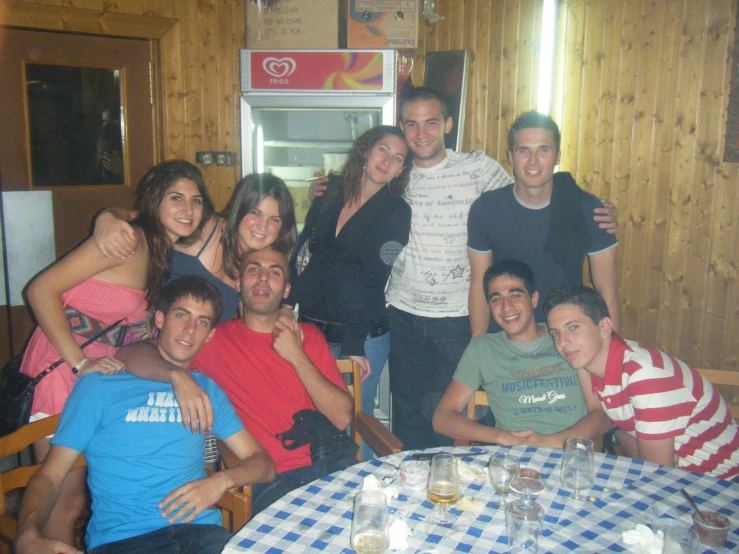 a group of people posing for a picture in front of a camera