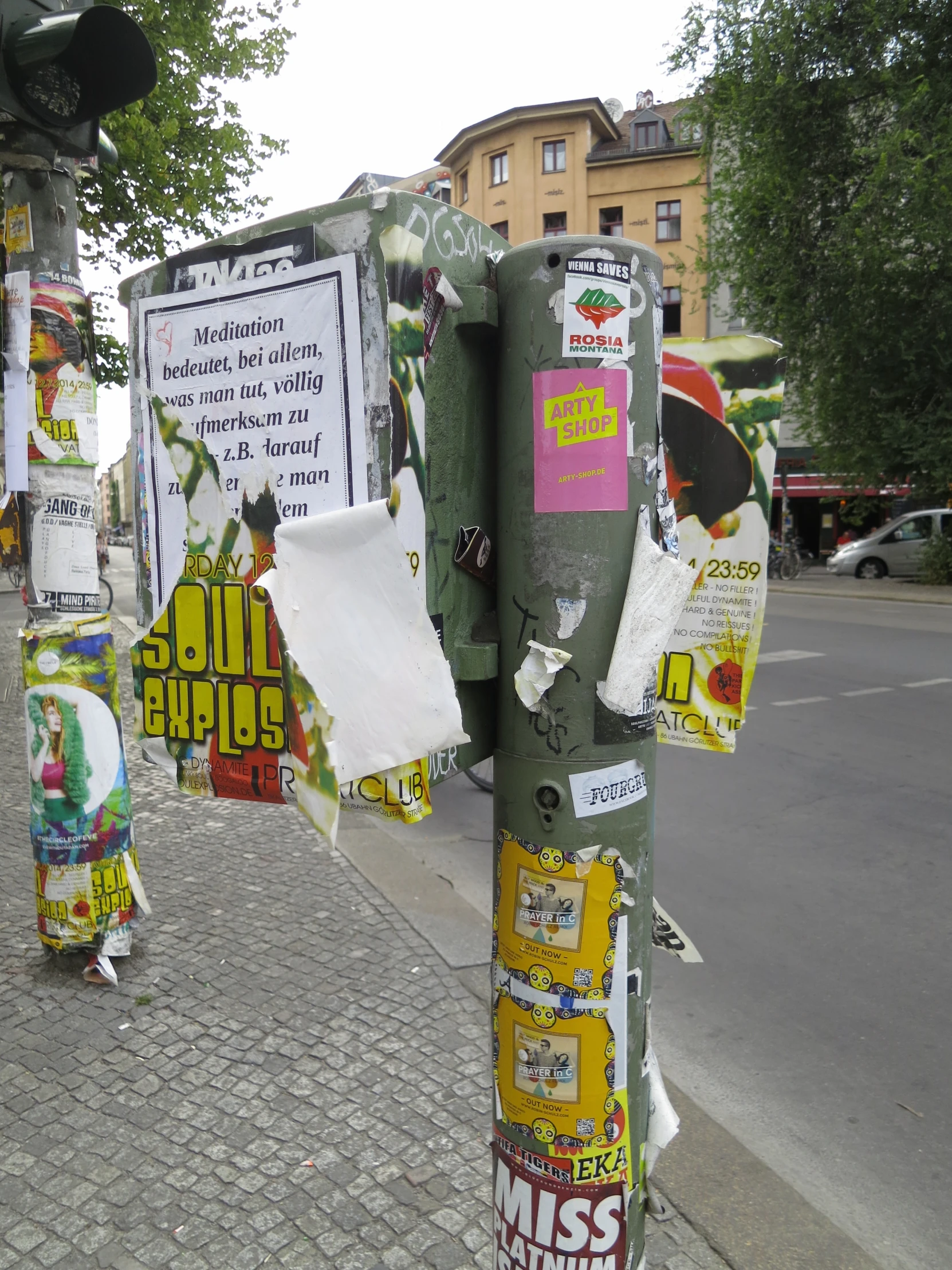 a parking meter that has various pieces of paper attached to it