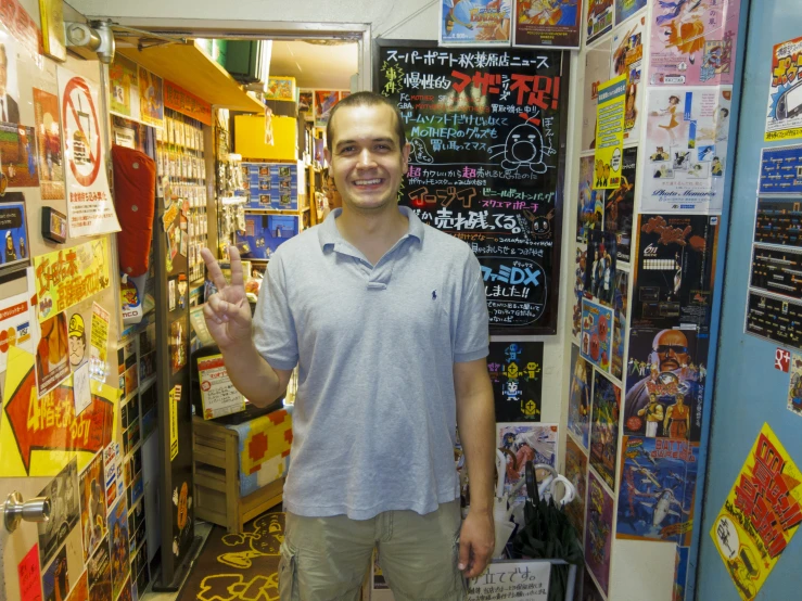 a man is standing in a store making a funny face