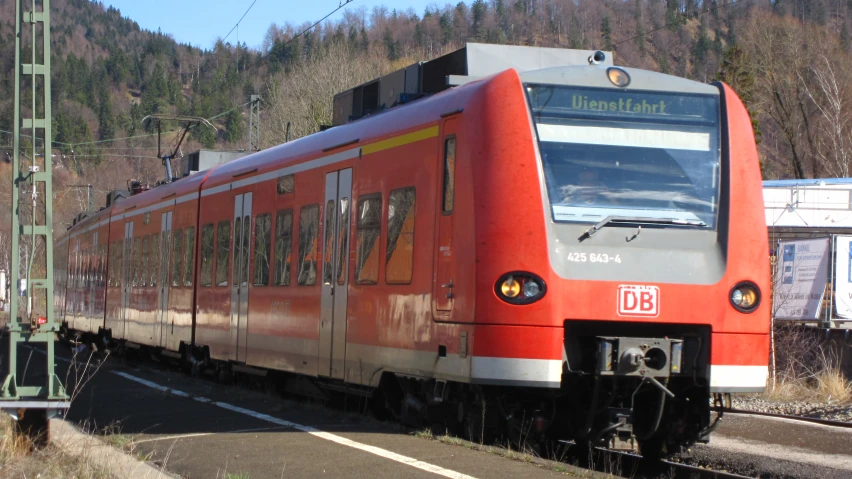 a train is pulling into a station on the tracks