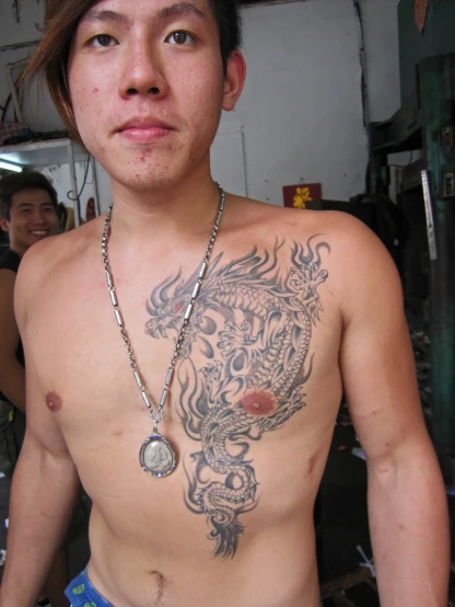 a tattooed man posing for a po in the room