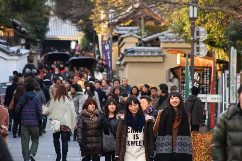 many people are walking down a busy street