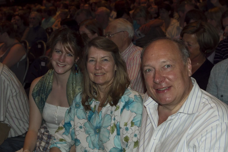 three people seated next to each other in front of an audience