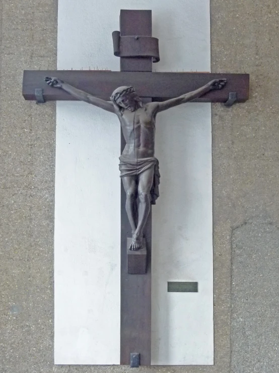 a stone cross on a wall in a building