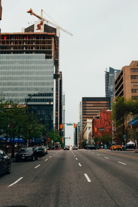 a car traveling down a street between tall buildings