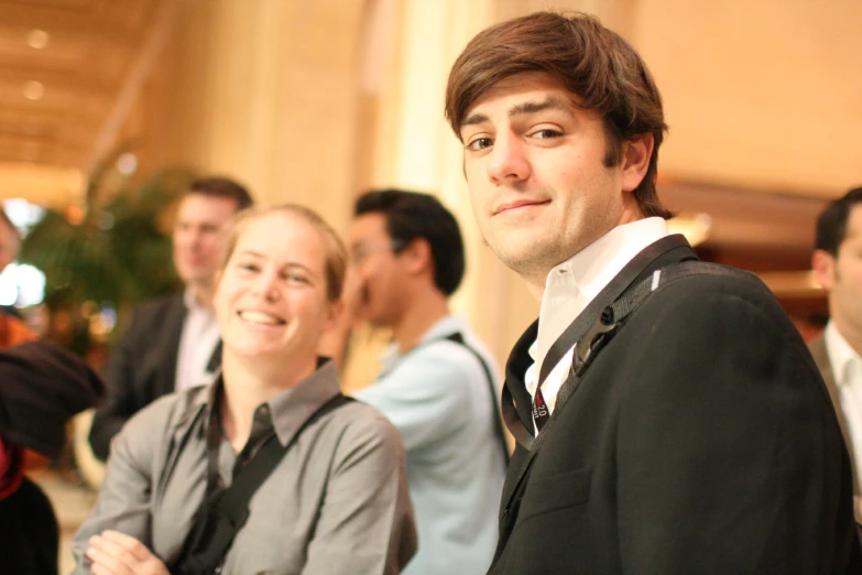 a man in a suit and other people behind him