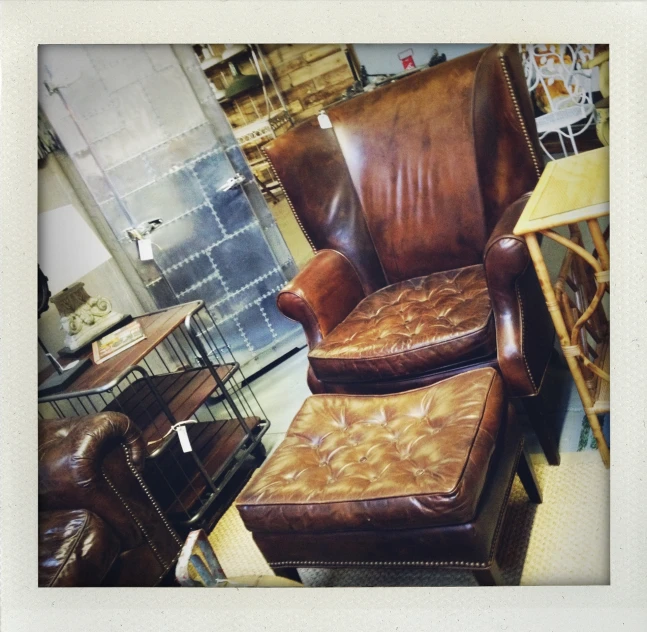 a chair and foot stool made of brown leather