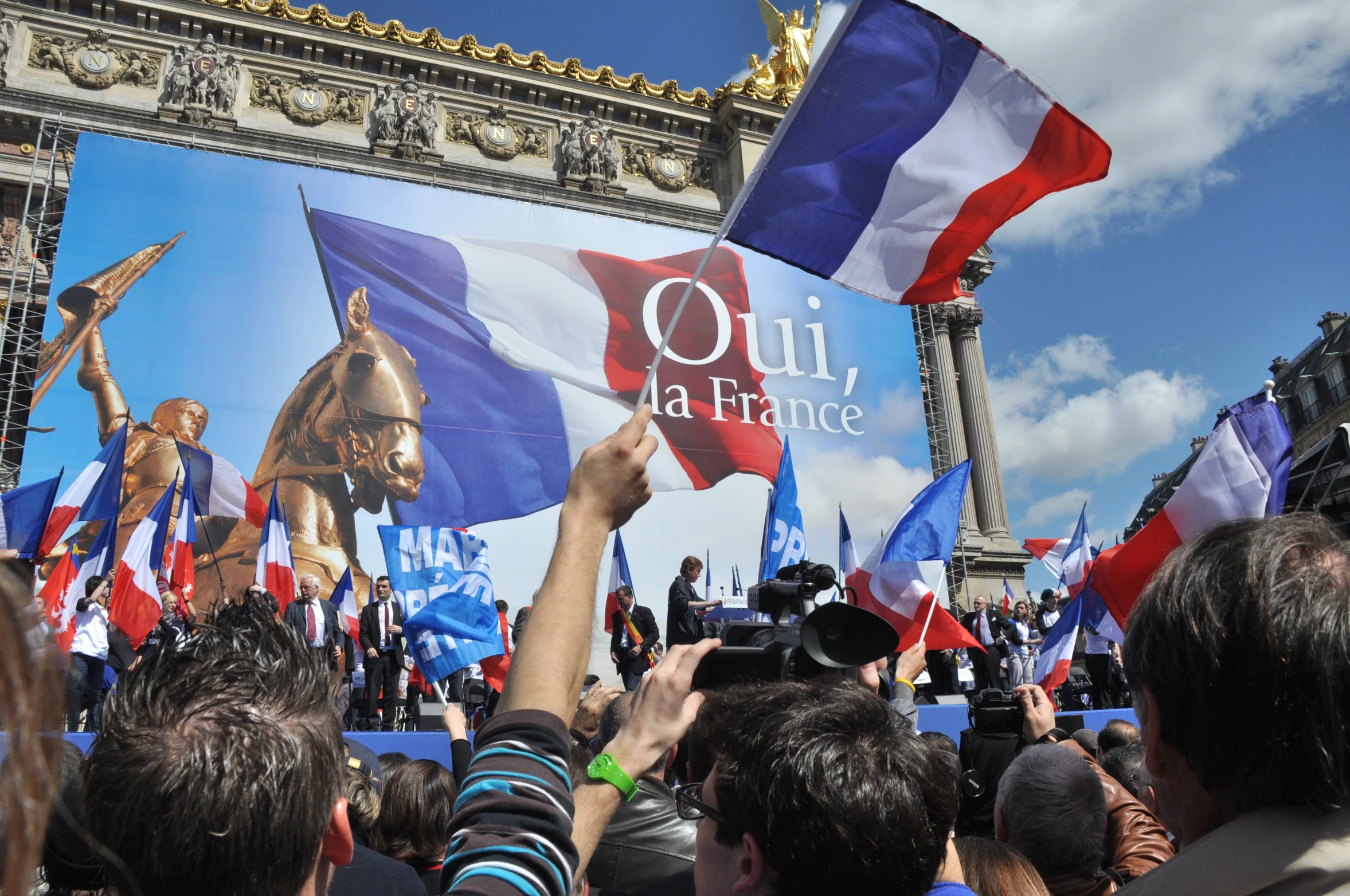 several people holding onto large posters in the street