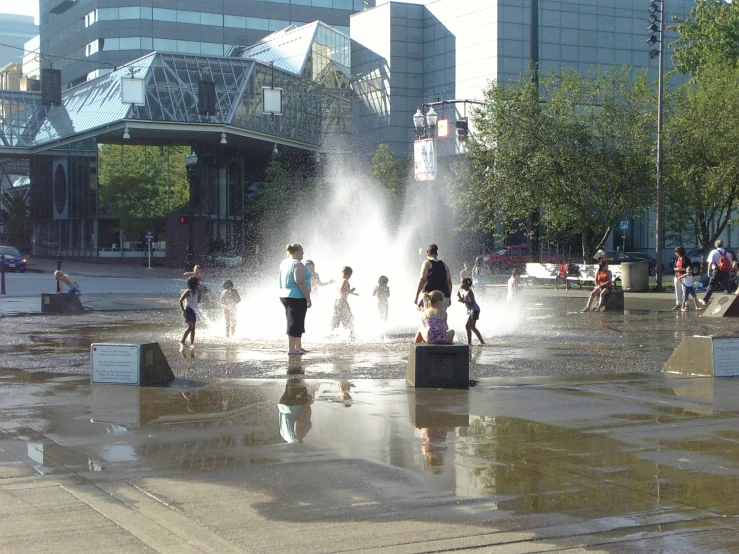 several people playing with a spray gun in a park