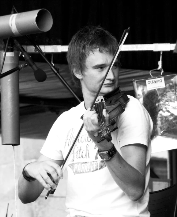 a man plays the violin on stage