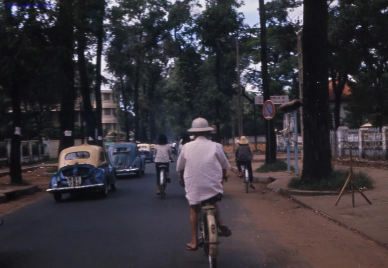 man in a white hat is riding on his bicycle