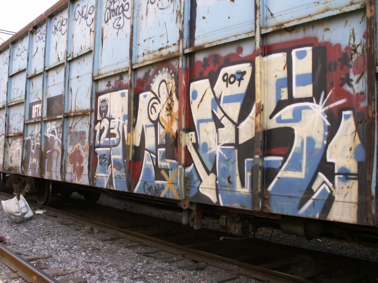 a train car covered in lots of graffitti