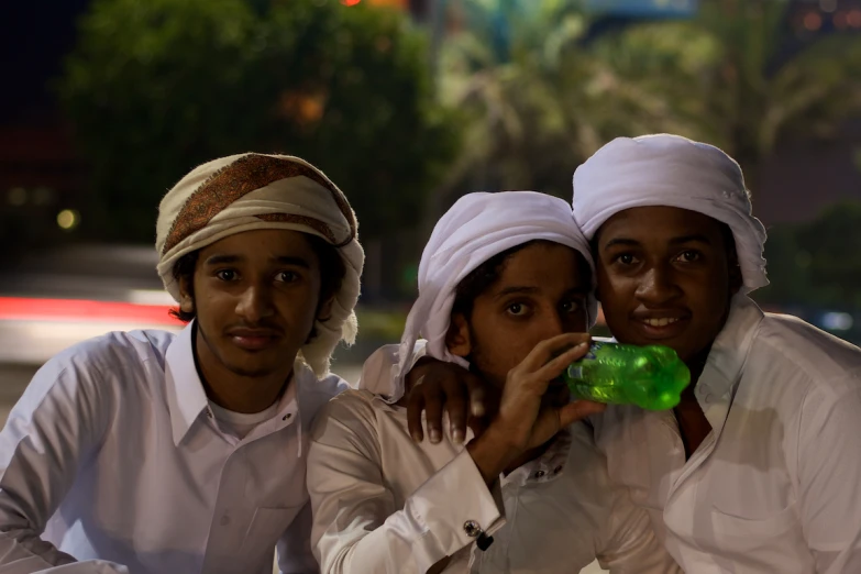 three people pose with each other in headdresses