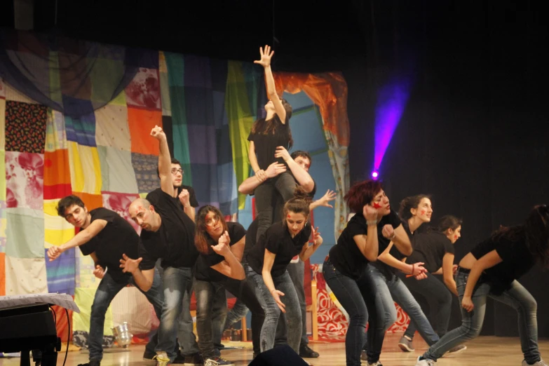 a group of men on stage, dancing with a woman