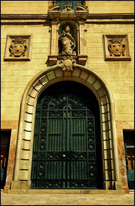 an arched doorway with a wrought iron door and door knocker