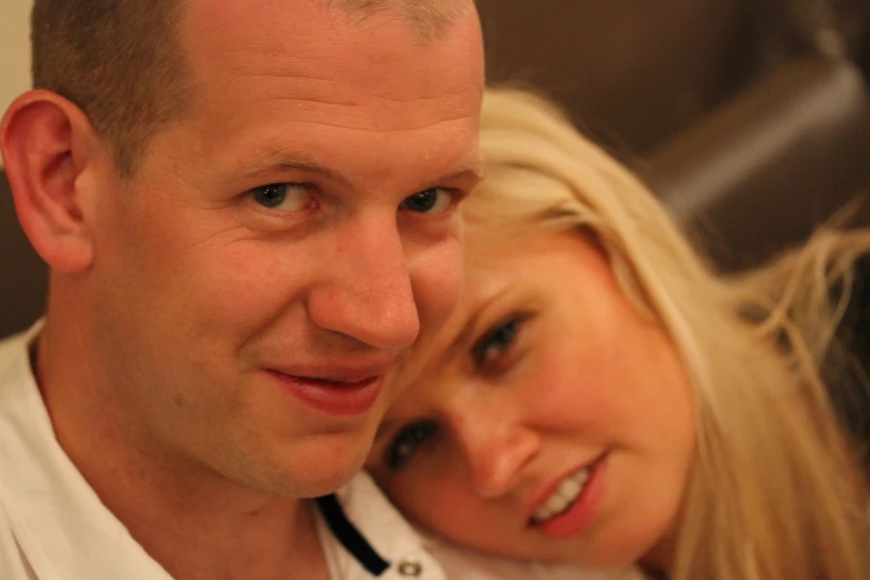 a woman and man taking a picture in the mirror