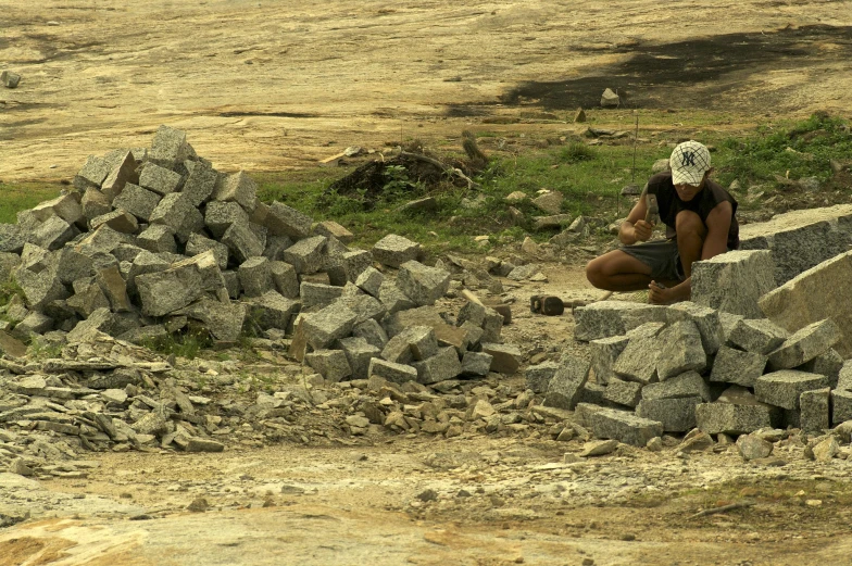 a man that is sitting down on some rocks