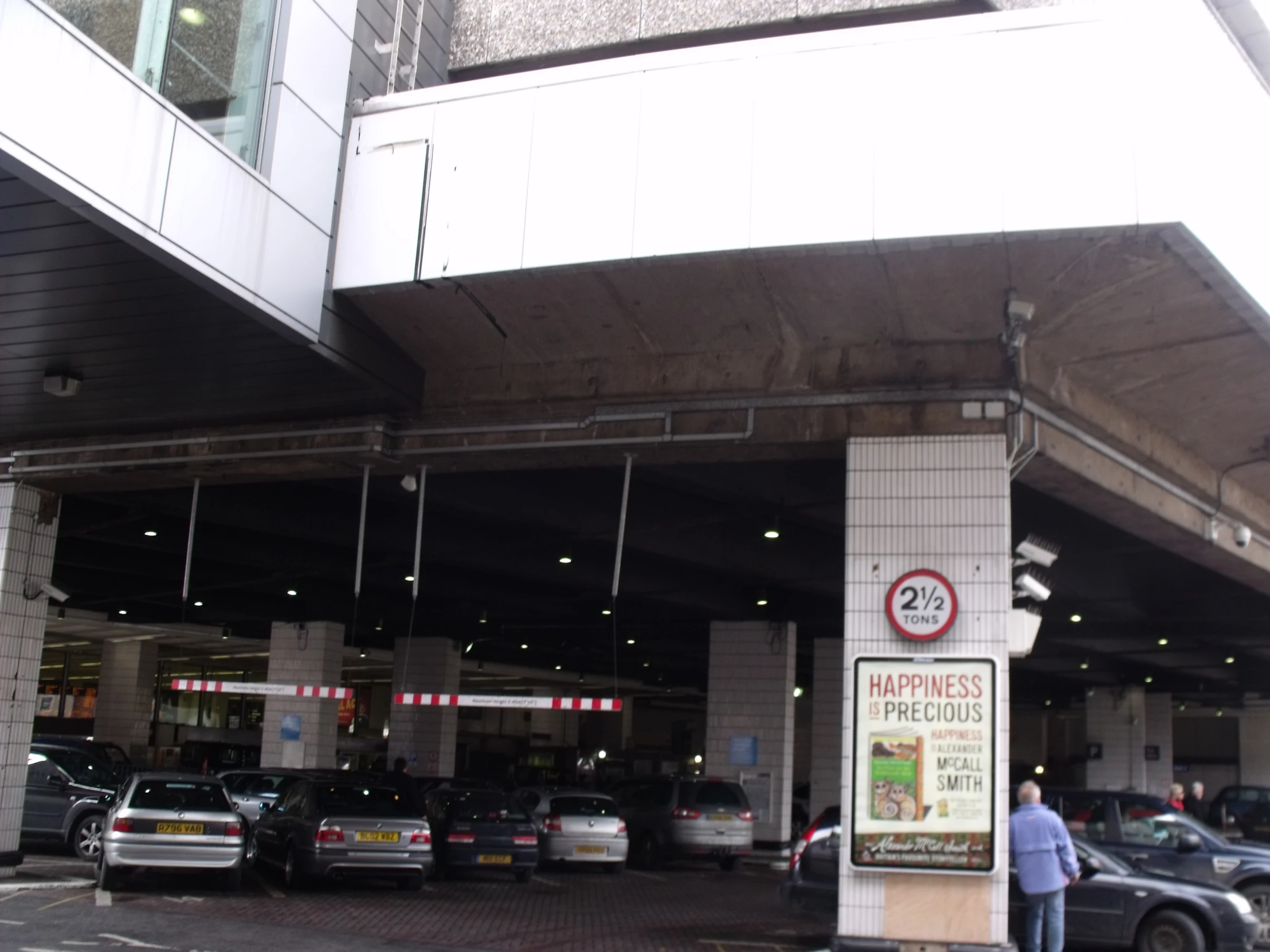 a man standing in front of a car covered garage