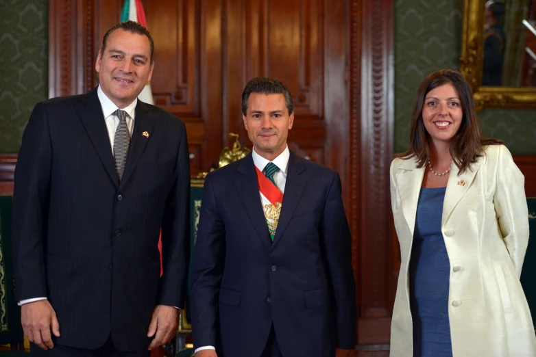 two people and a man in suits smiling