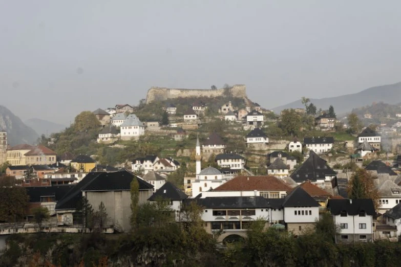 a city with lots of houses sitting on a hillside