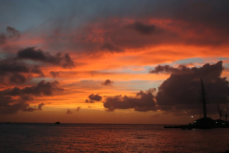 bright sunset over the ocean with boats on it