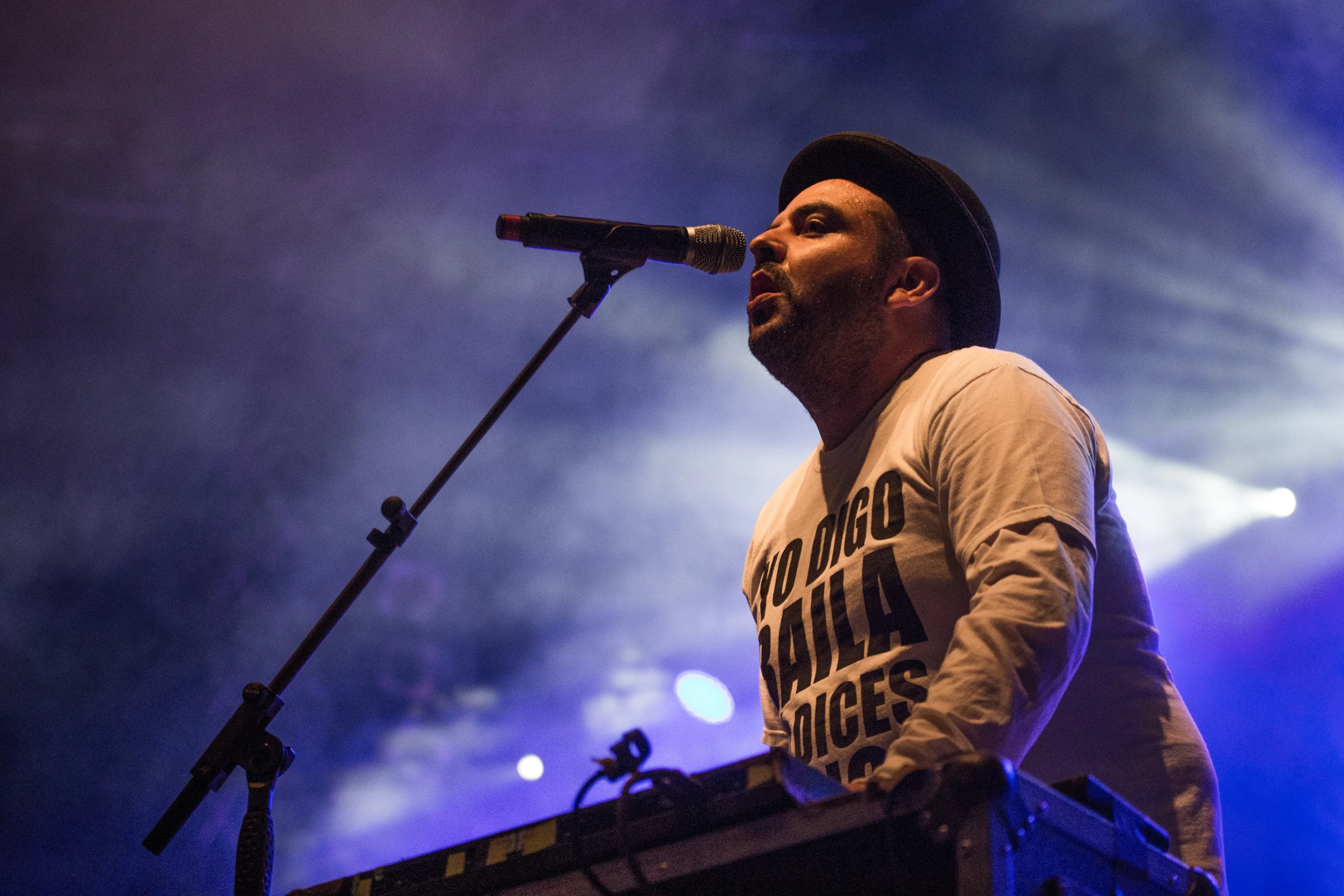 a man on a keyboard playing music on a stage