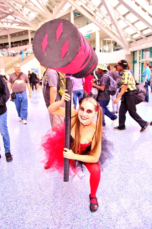 a woman poses as she stands on a pole