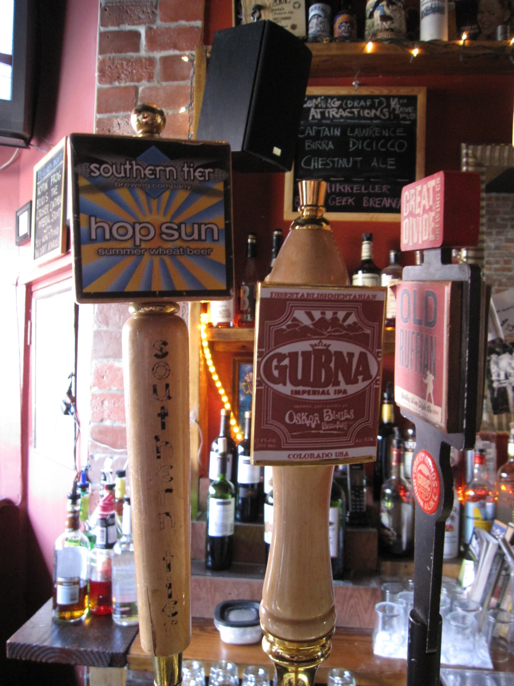 a tall beer lamp next to several other items on a counter