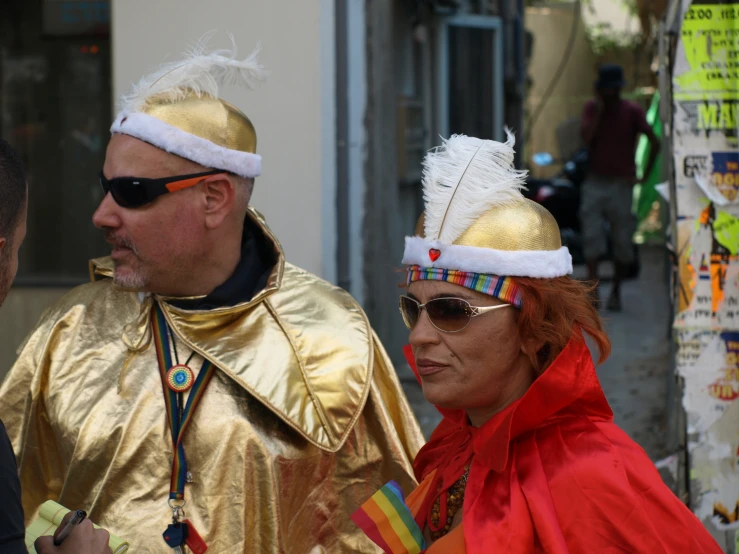 two men and one woman in costumes with shades on