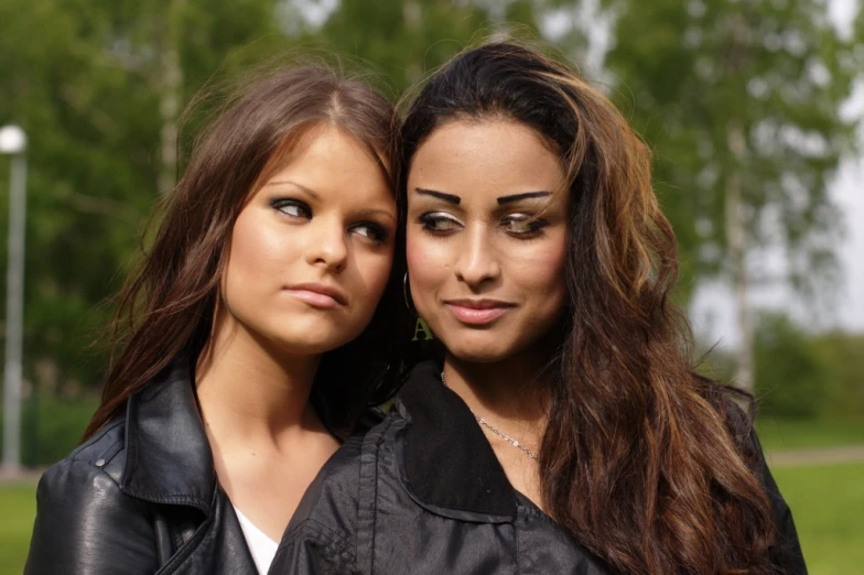 two beautiful young women standing next to each other