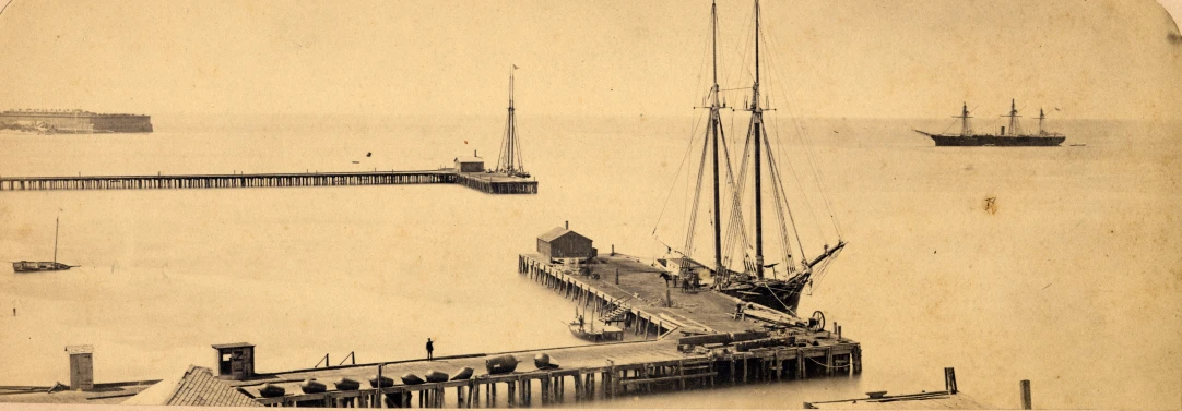 a large ship sailing past a dock on top of water