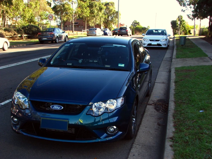 a blue car that is parked in the road