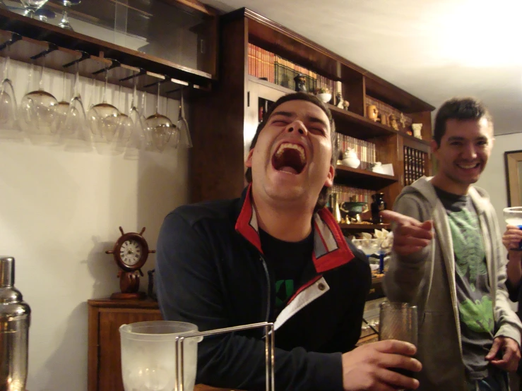 two men smiling and laughing in a home