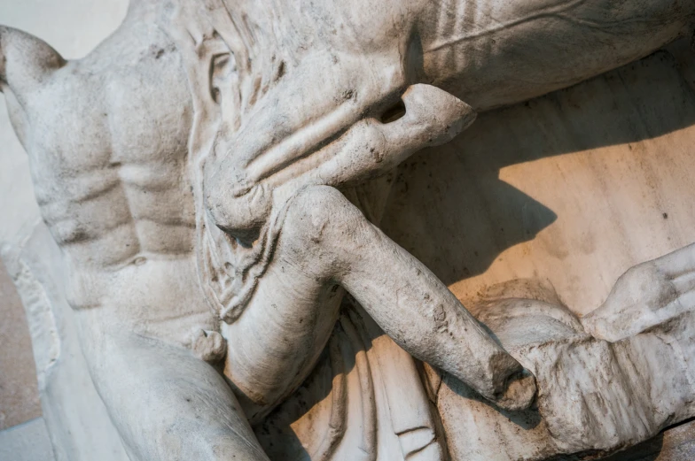 a marble statue with two faces of men and a baby