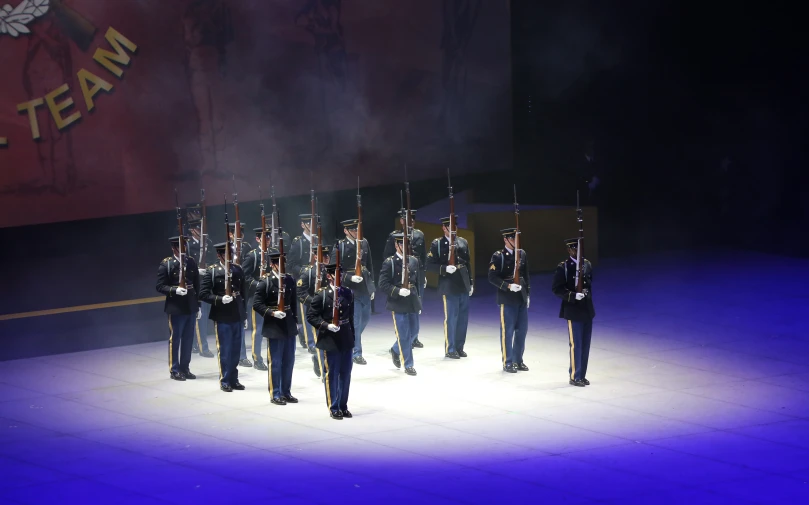 men in military uniform at the foot of a stage